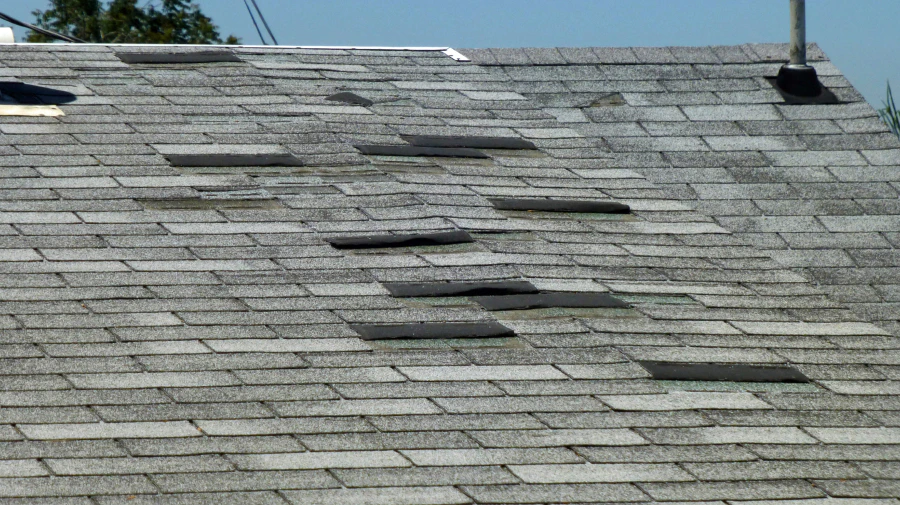 damaged shingle roof after a storm blue springs mo